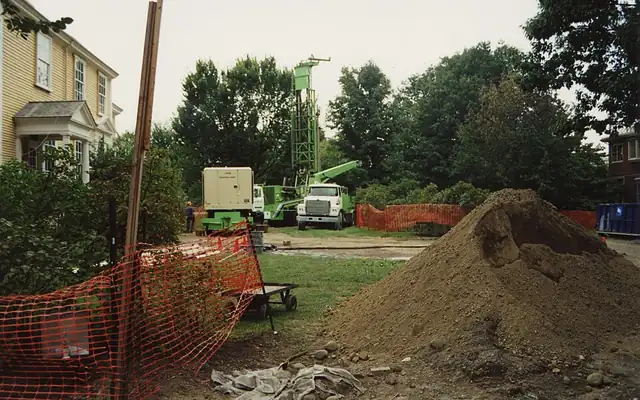 Pile of fill dirt on a work site beside a house