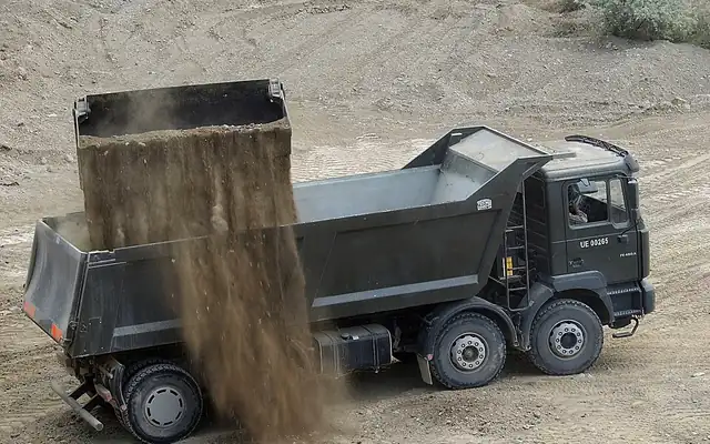 Dump truck tipping a load of dirt