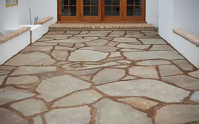 Irregular bluestone flagstone patio at a doorway