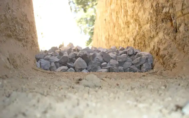 Drainage trench with a bed of gravel at the bottom
