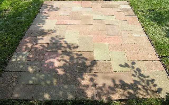 Brick paver patio laid on a lawn