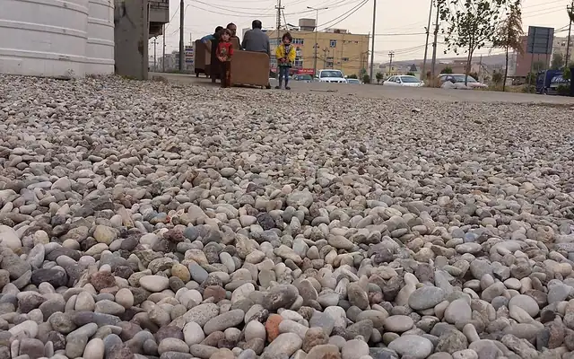 Ground covered with small rounded pea gravel