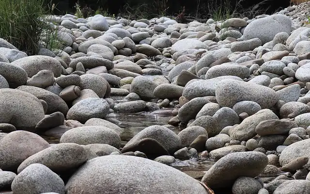 Large rounded river rocks along a stream bed